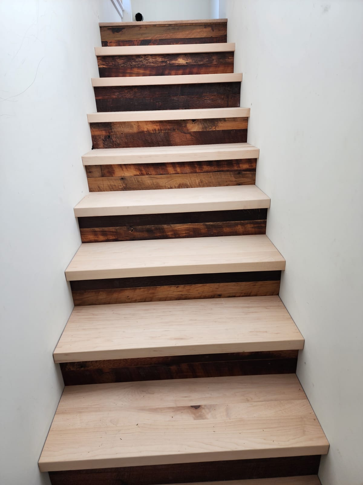 Custom stair treads and reclaimed wood risers installed by OnSite Flooring