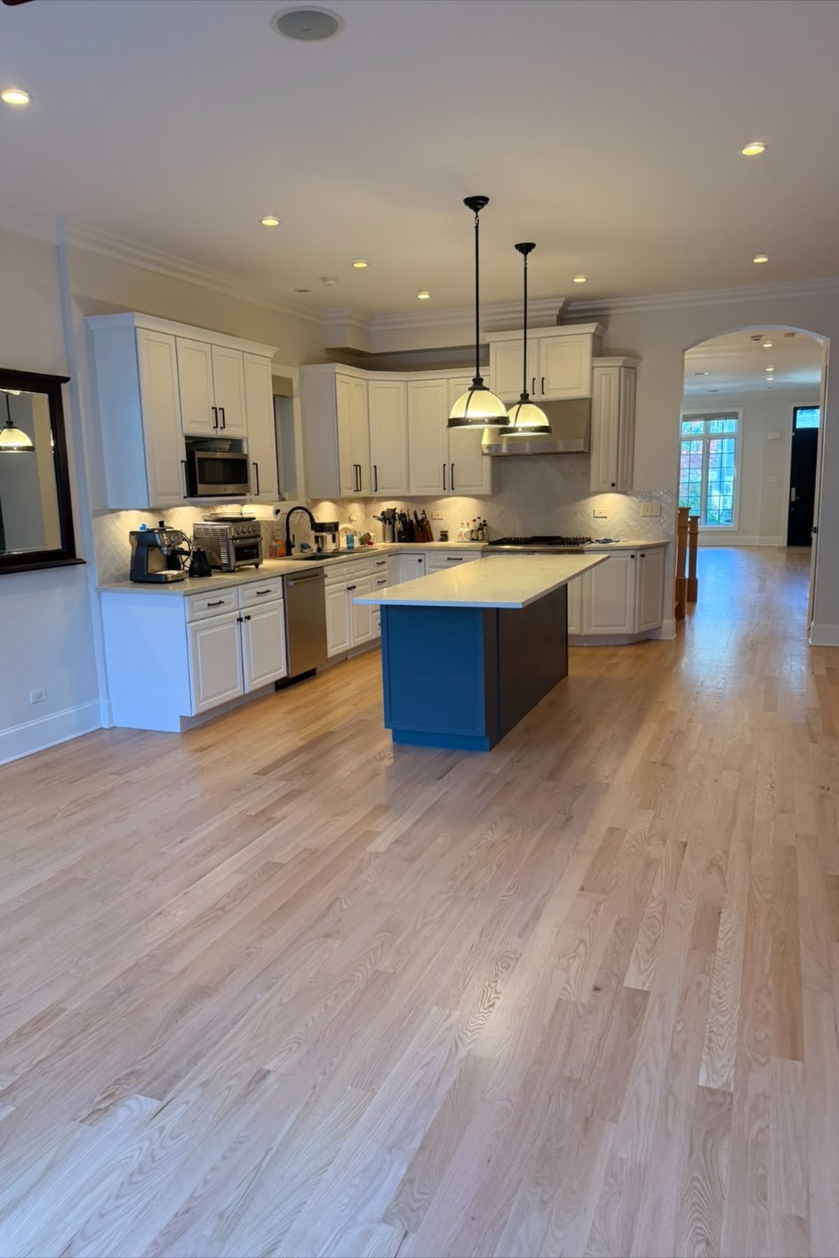 Natural oak flooring installed throughout a custom kitchen by OnSite Flooring
