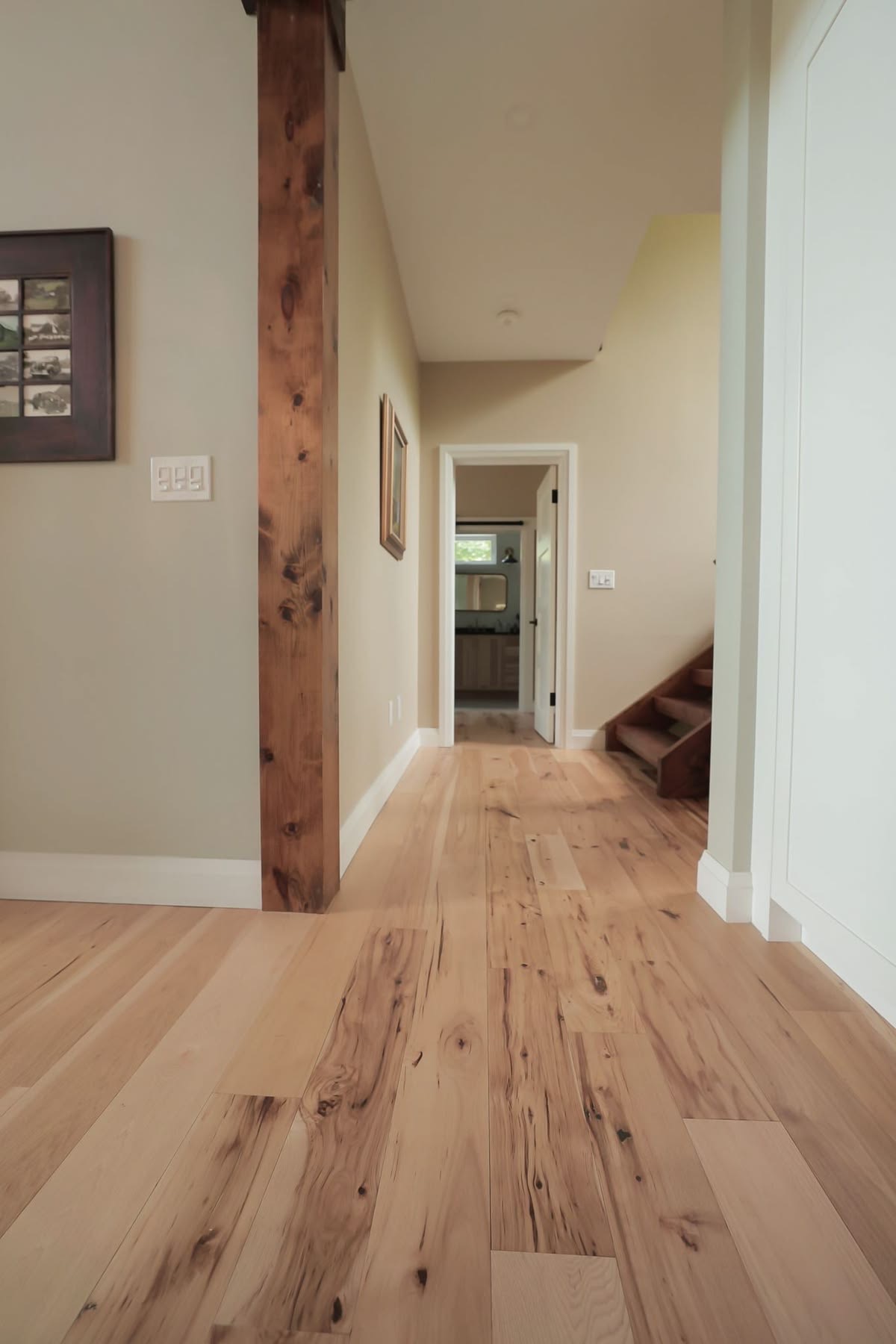 Light oak flooring installed through a hallway by OnSite Flooring