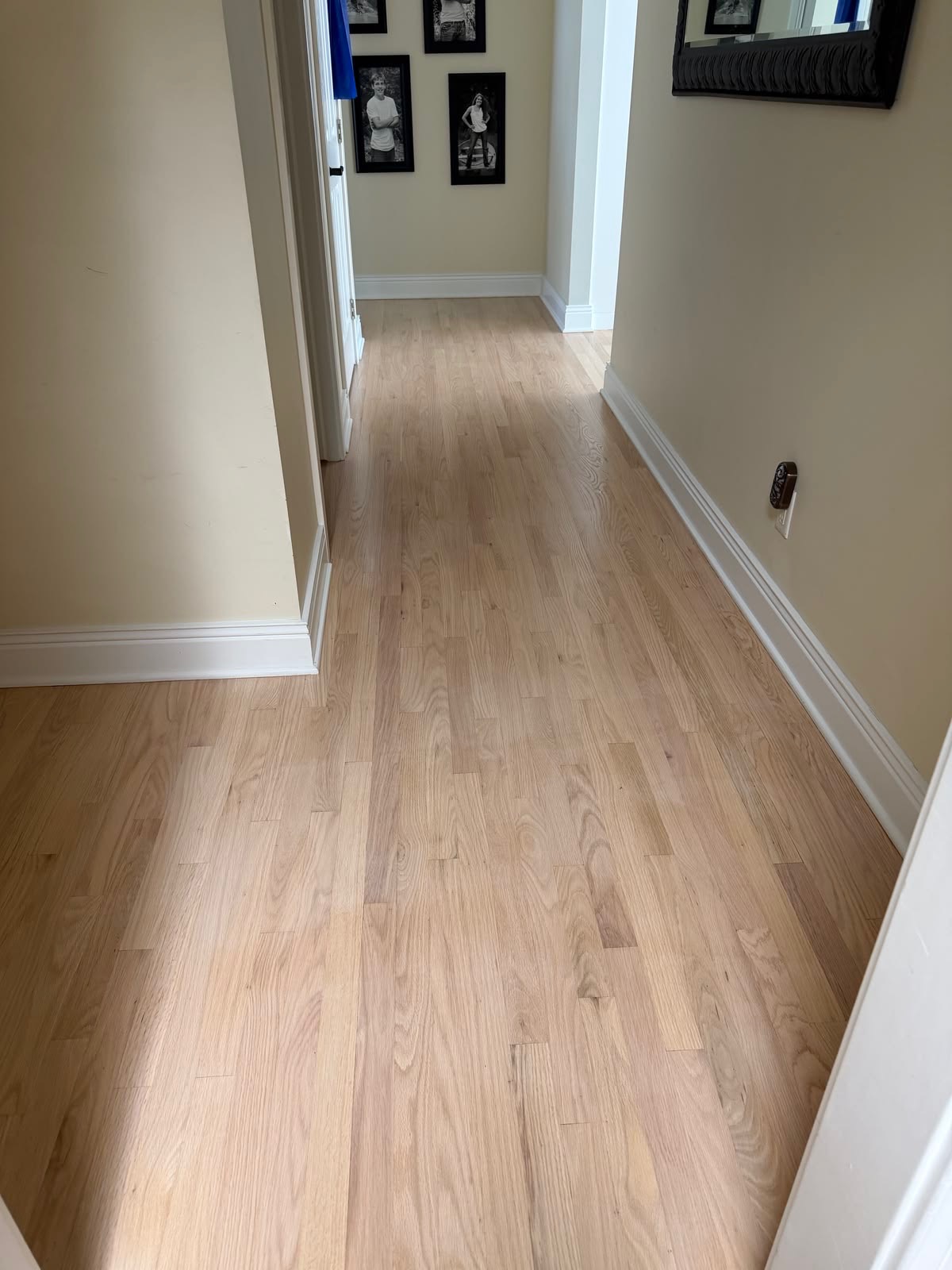 Light natural oak flooring installed in an upstairs hallway